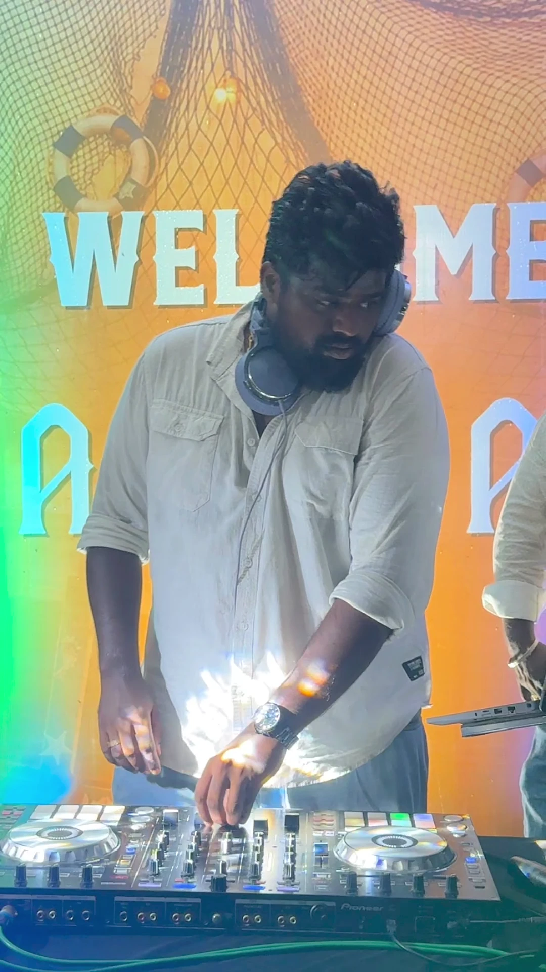 DJ MarvelMax at the decks during an outdoor evening celebration